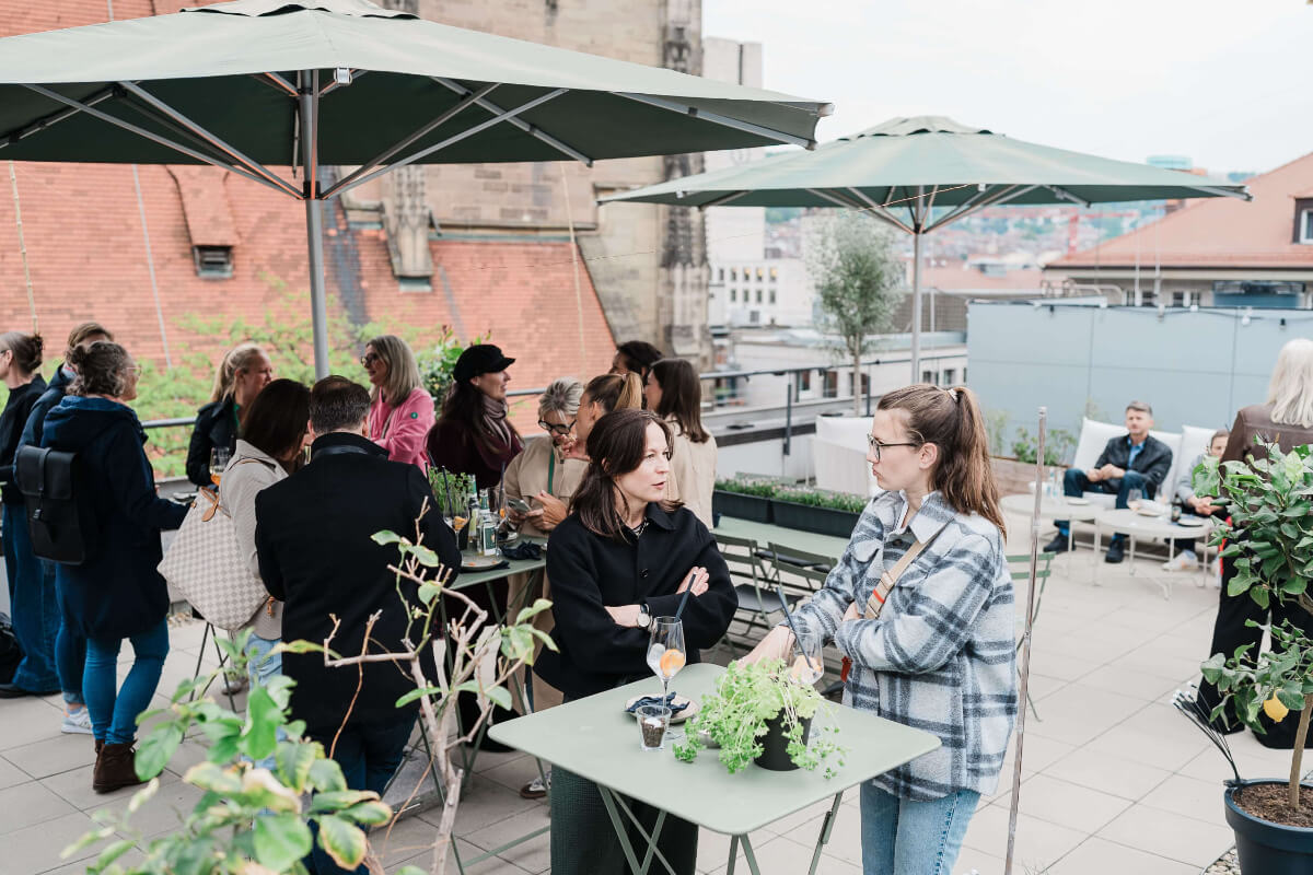 Guests networking on the rooftop terrace of an urban event venue